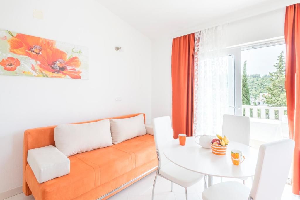 a living room with a couch and a table at Apartments Nikolina in Hvar