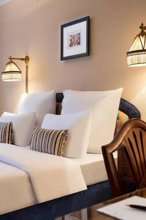 a living room with a couch and pillows at Hotel Barsey by Warwick in Brussels