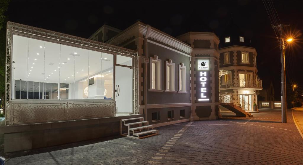 a building with a store front at night at Castello Boutique Hotel in Čačak