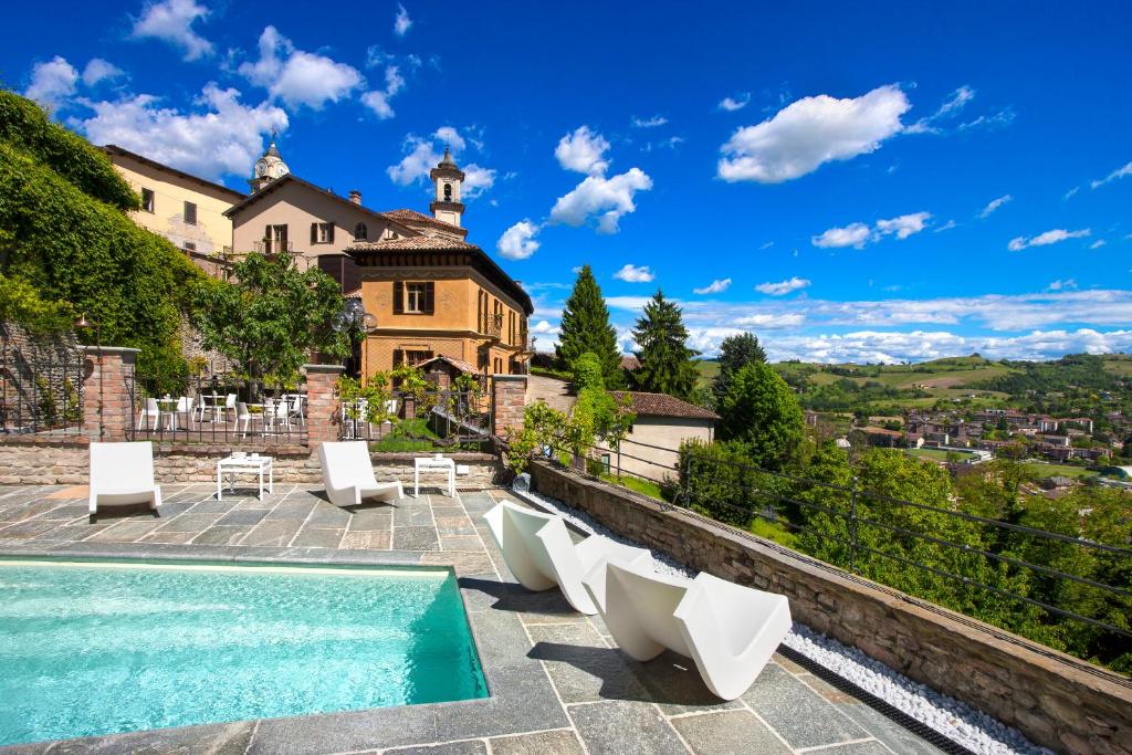 a villa with a swimming pool and a house at Relais Villa del Borgo in Canelli