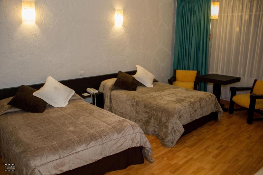 Postel nebo postele na pokoji v ubytování Gran Hotel Xalapa