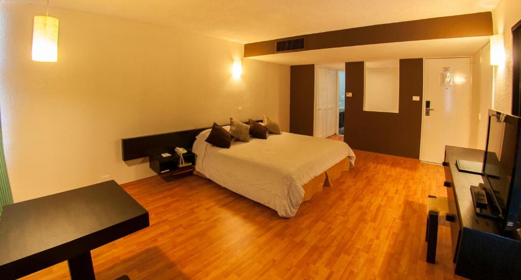Postel nebo postele na pokoji v ubytování Gran Hotel Xalapa
