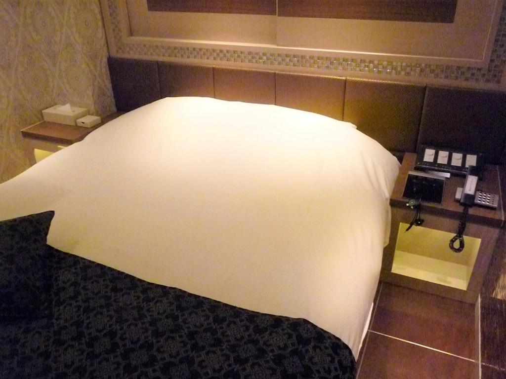 Postel nebo postele na pokoji v ubytování Hotel Lei