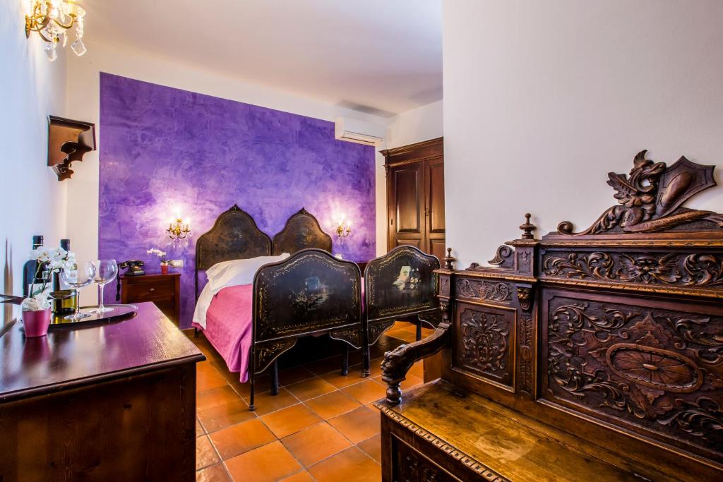 Łóżko lub łóżka w pokoju w obiekcie Palazzo Giunta - Porta Marina Ortigia