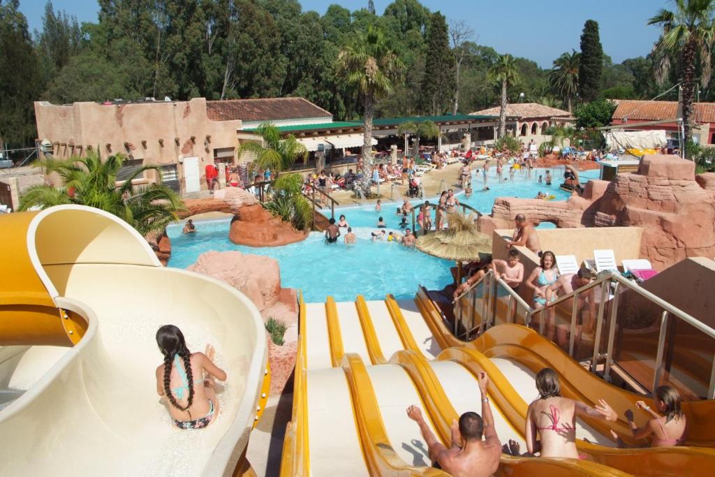 um grupo de pessoas numa piscina num resort em Camping Les Palmiers em Hyères