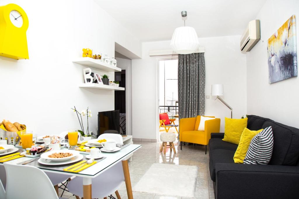 a living room with a table and yellow chairs at Gennadi Holiday Home in Gennadi