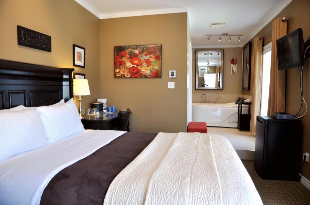 Postel nebo postele na pokoji v ubytování Motel des Cèdres