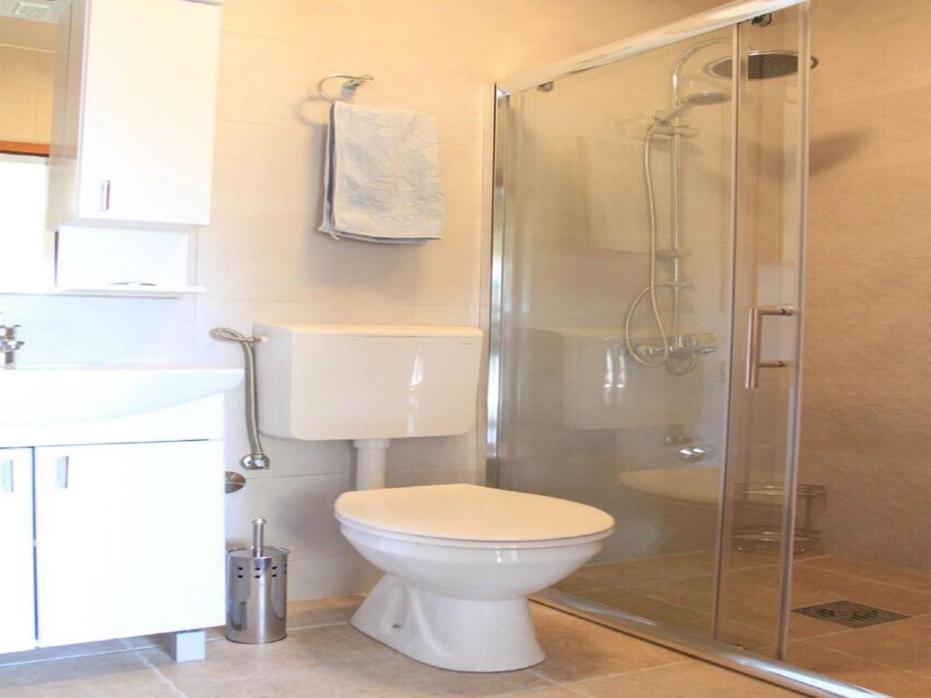 a bathroom with a toilet and a shower at Hortus Apartments in Sveti Stefan