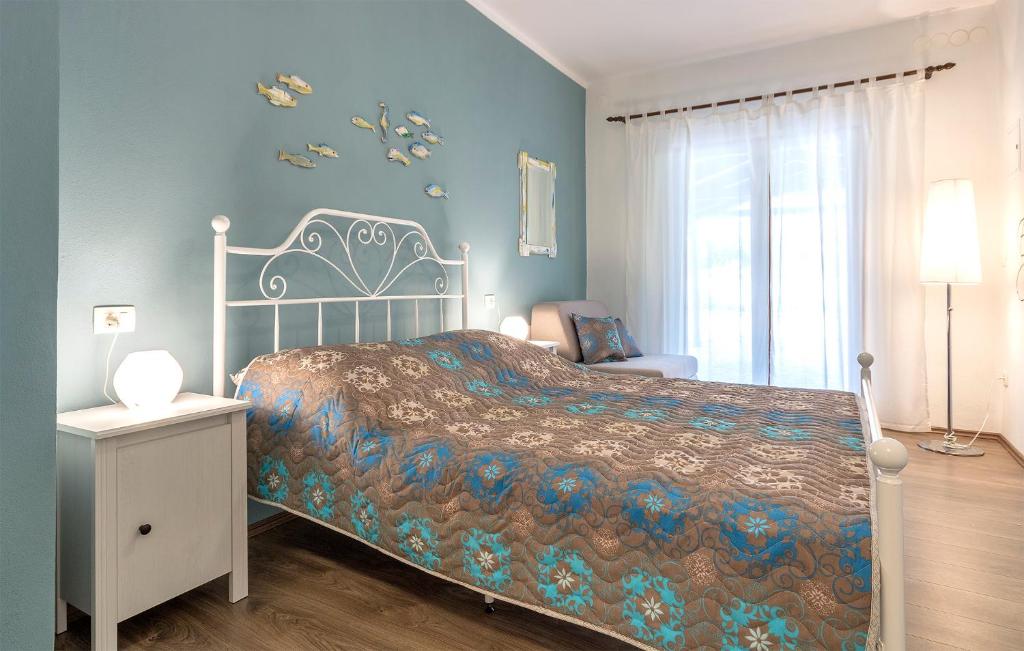um quarto com uma cama e uma parede azul em Apartment Rio em Fažana