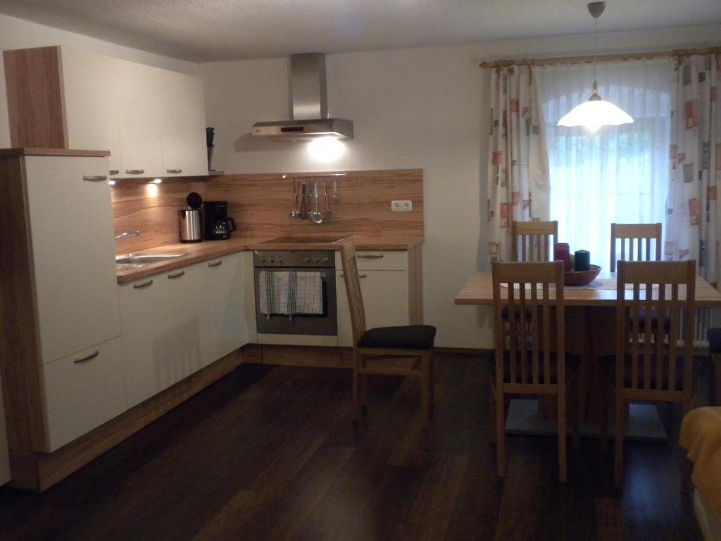 a kitchen and dining room with a table and a dining room at Bio-Urlaubshof Dansbach in Spital am Pyhrn