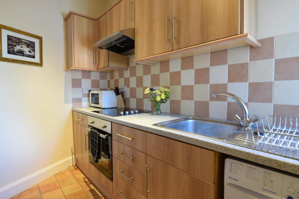 a kitchen with a sink and a counter top at Mansfield Apartment in Hawick
