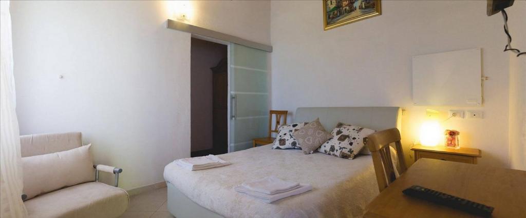 a small bedroom with a bed and a table at Borgo Foce La Spezia SP2389 in La Foce