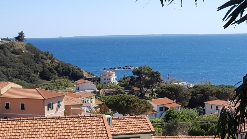 a view of a town with the ocean in the background at Casa Tina in Pomonte