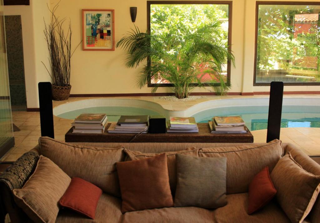 a living room with a couch in front of a swimming pool at Luxury house in the heart of Tenerife in Las Lagunas