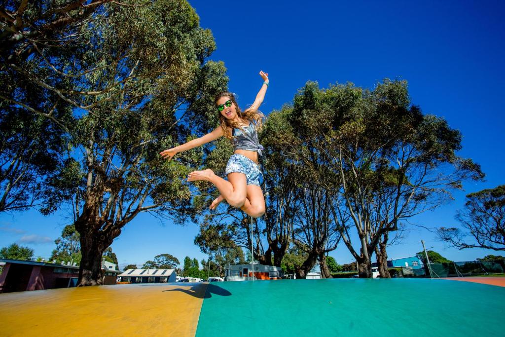 a woman jumping in the air on a skateboard at BIG4 Ulverstone Holiday Park in Ulverstone