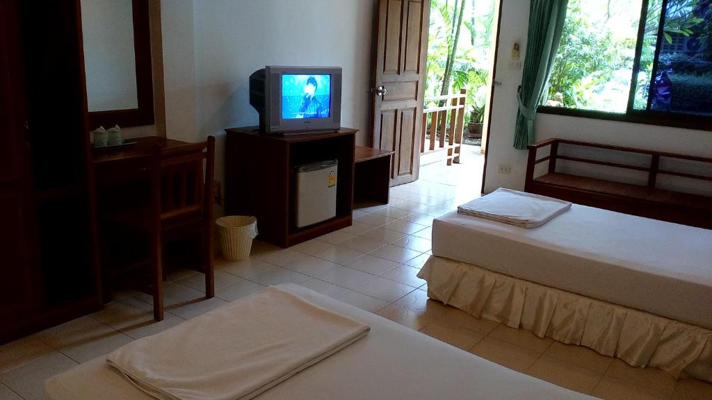 Postel nebo postele na pokoji v ubytování Baan Pitcha บ้านพิชชา