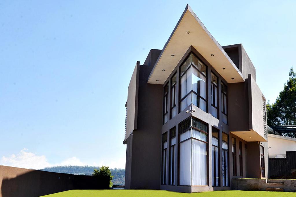 a black and white building with a pointed roof at Kingsford Residences in Nuwara Eliya