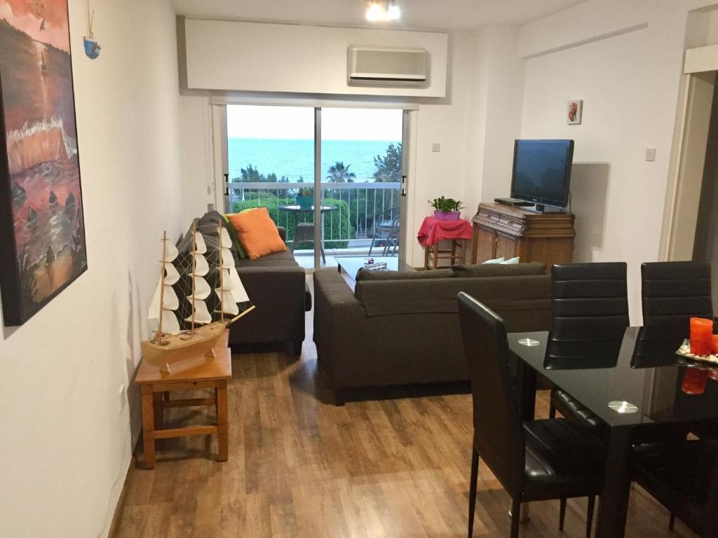 a living room with a couch and a table at Sea View Apartment in Limassol