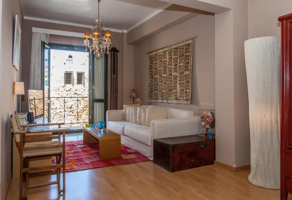 a living room with a white couch and a table at Spolia Art Maison in Chania Town
