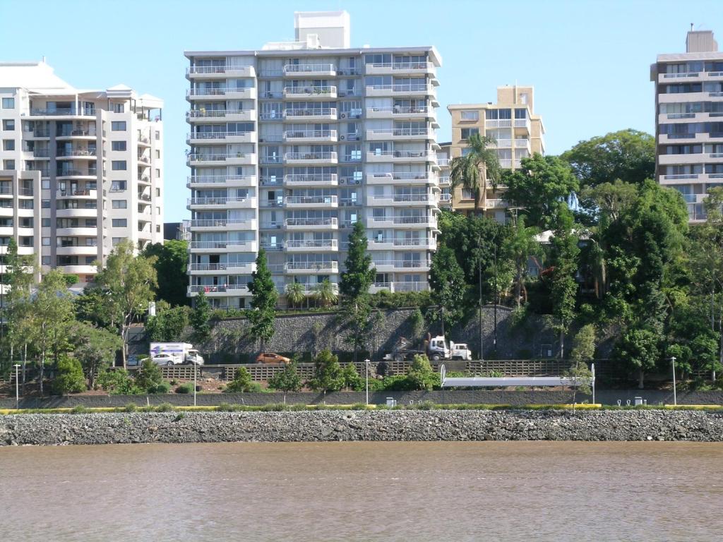 a view of tall buildings from a river with buildings at Fairthorpe Apartments in Brisbane