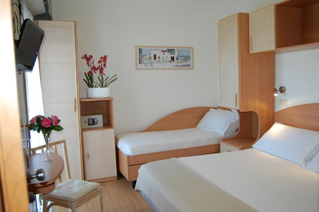 Postel nebo postele na pokoji v ubytování Hotel Rivazzurra