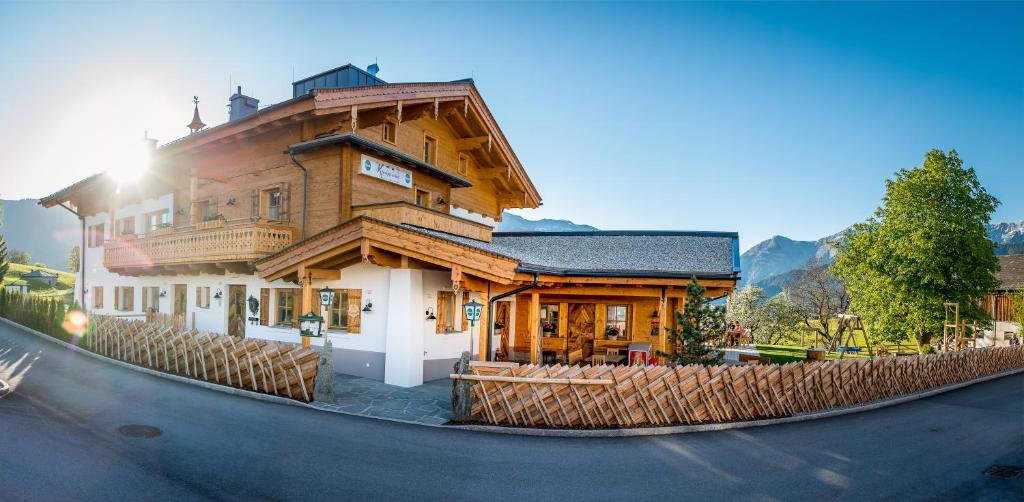 a large wooden house on the side of a street at Klampfererhof in Saalfelden am Steinernen Meer