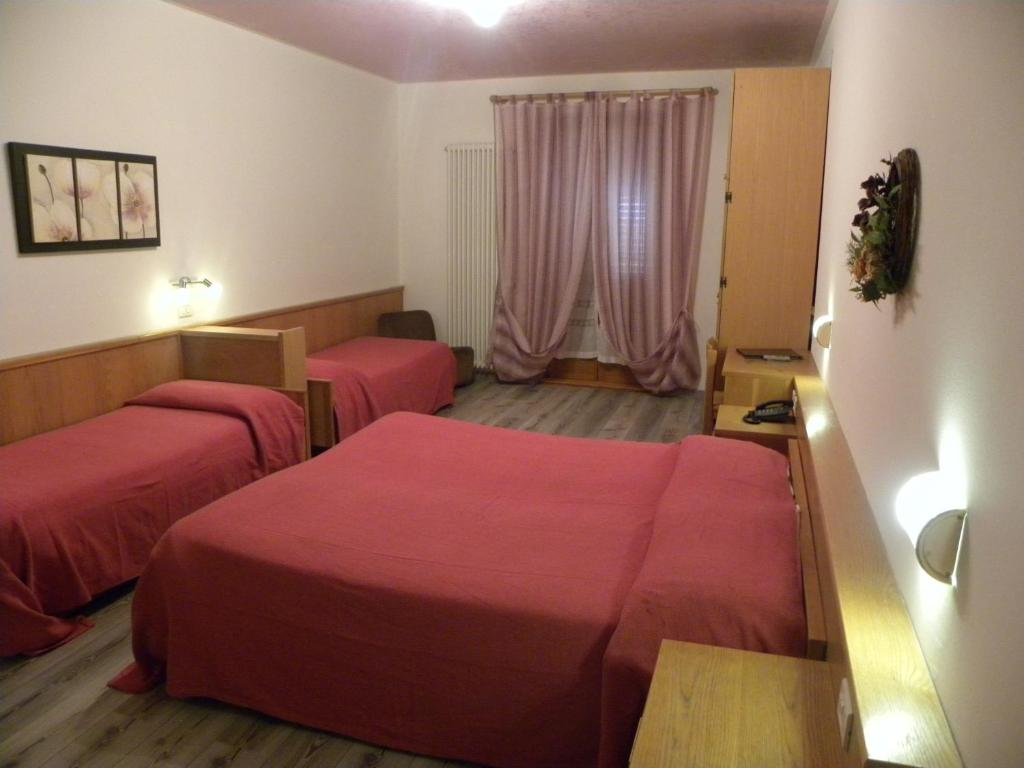 Postel nebo postele na pokoji v ubytování Hotel Cova