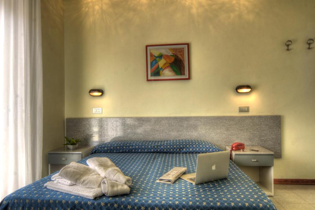 Postel nebo postele na pokoji v ubytování Hotel Reggiana