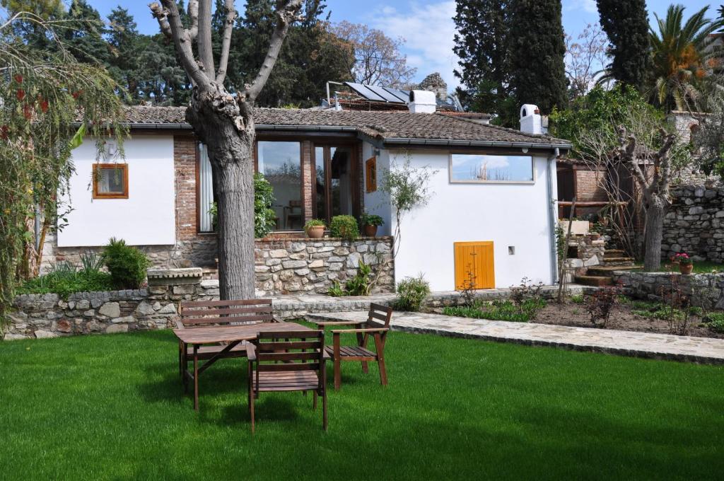 a table and chairs in front of a house at Garden House in Selçuk