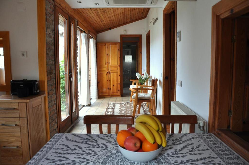 a bowl of fruit on a table in a kitchen at Garden House in Selçuk