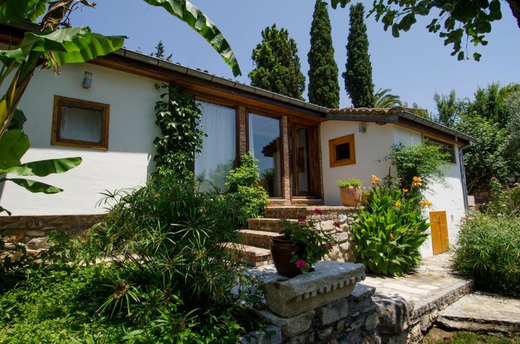 a cottage with a garden and stairs to the front door at Garden House in Selçuk
