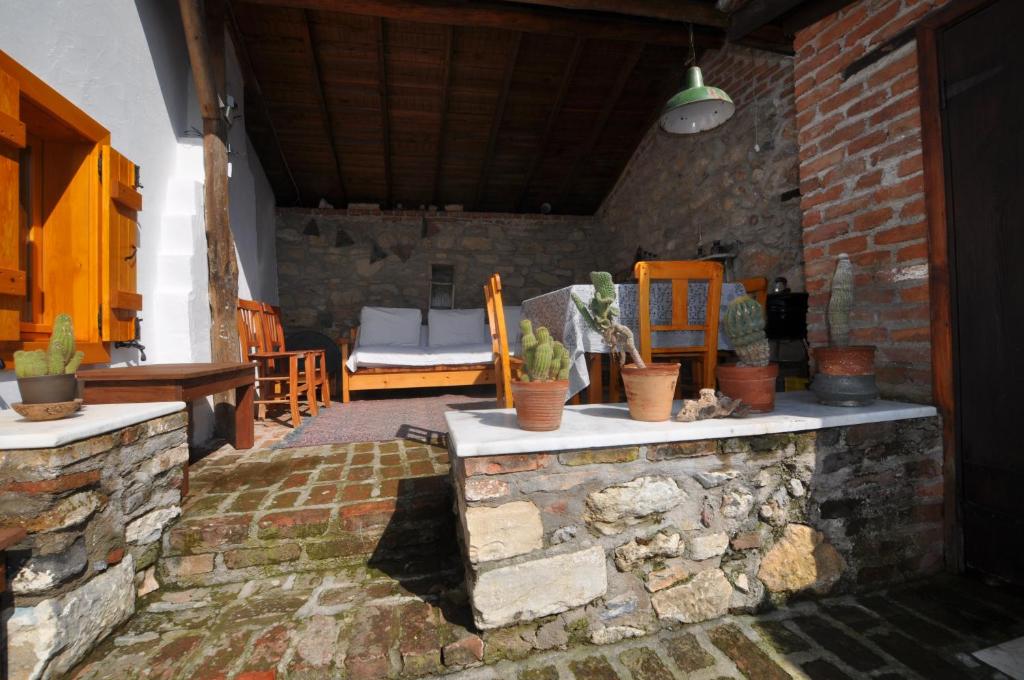 a patio with a stone counter with potted plants on it at Garden House in Selçuk