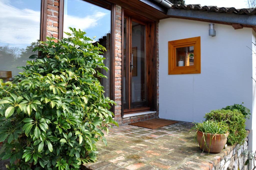 a porch of a house with plants and a window at Garden House in Selçuk