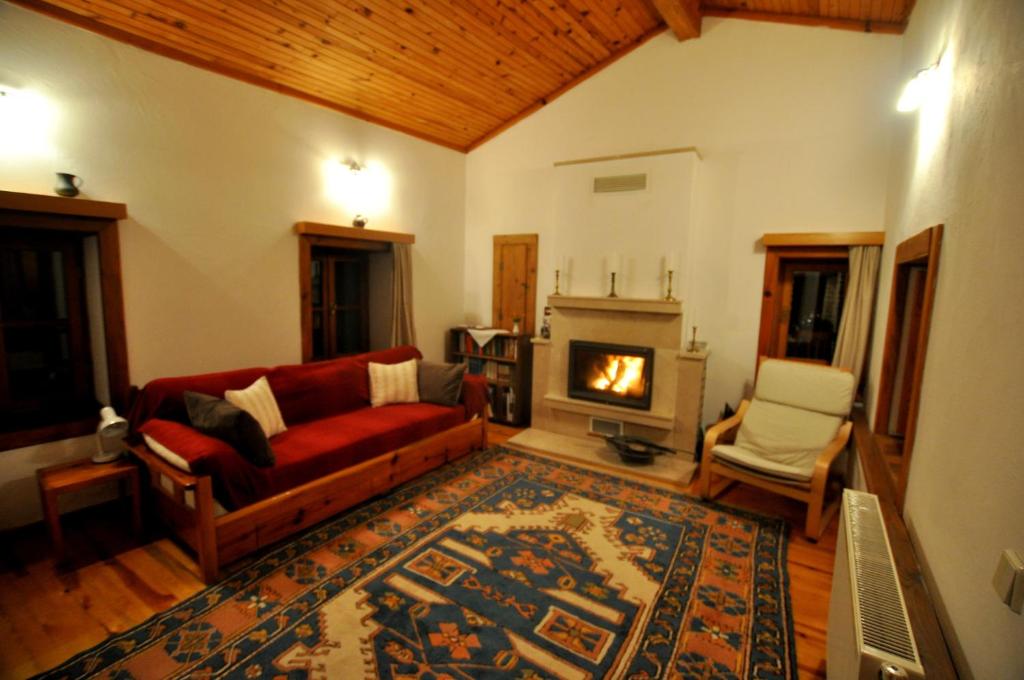 a living room with a couch and a fireplace at Garden House in Selçuk