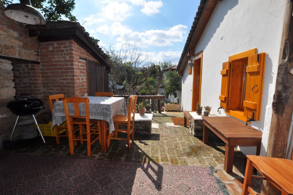 a patio with a table and some chairs and a table and chairsktop at Garden House in Selçuk