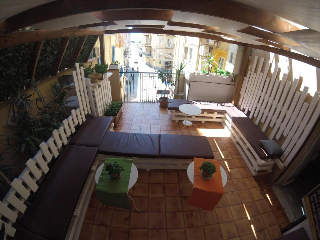 an overhead view of a balcony with tables and chairs at B&B La Giara in Porto Empedocle