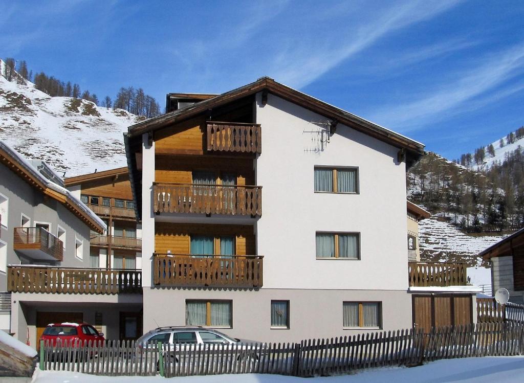 a apartment building with a balcony in the snow at Chasa Arlu in Samnaun