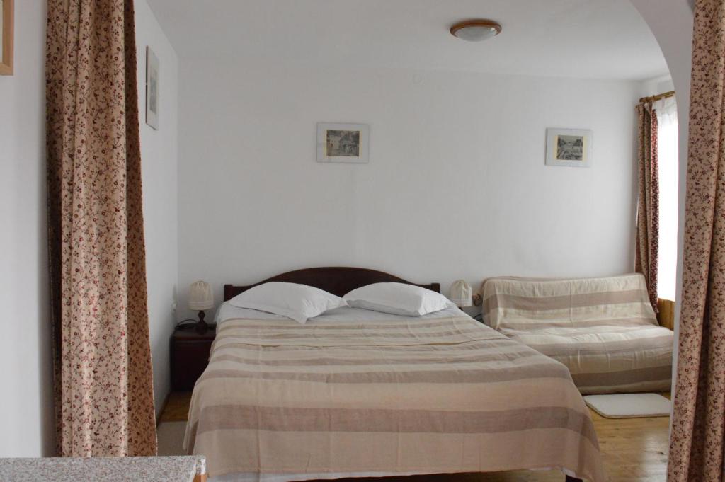a bedroom with a bed and a chair at Central city AP in Sibiu
