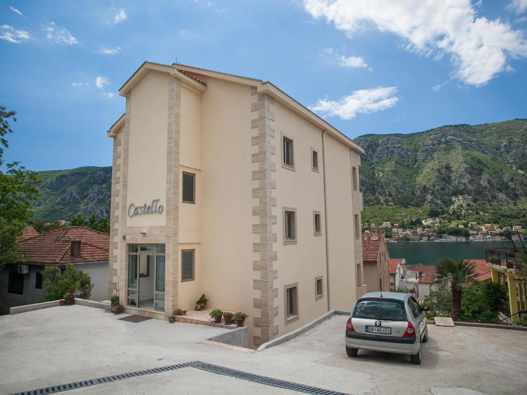 a car parked in a parking lot in front of a building at Apartments Castello in Kotor