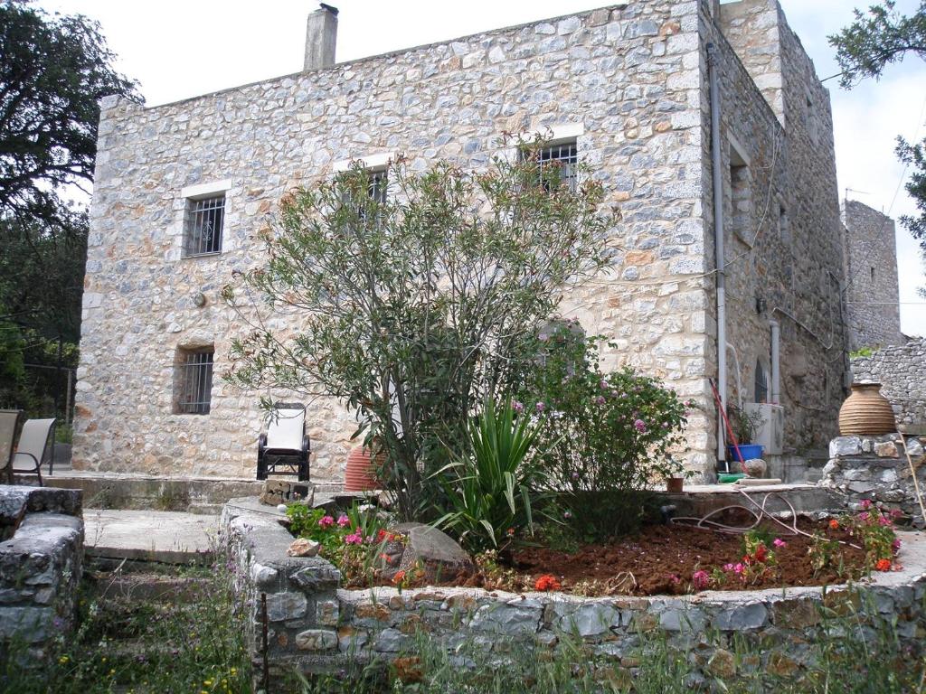 a stone house with a garden in front of it at Miki's Castle in Láyia
