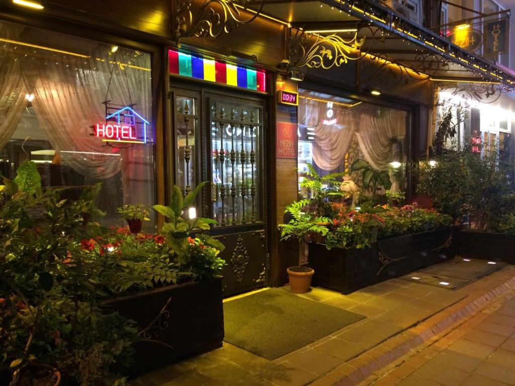 a flower shop with a neon sign on the door at Hotel Nezih Istanbul in Istanbul