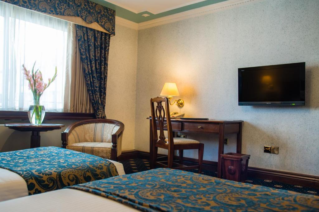 Postel nebo postele na pokoji v ubytování Sarova Stanley