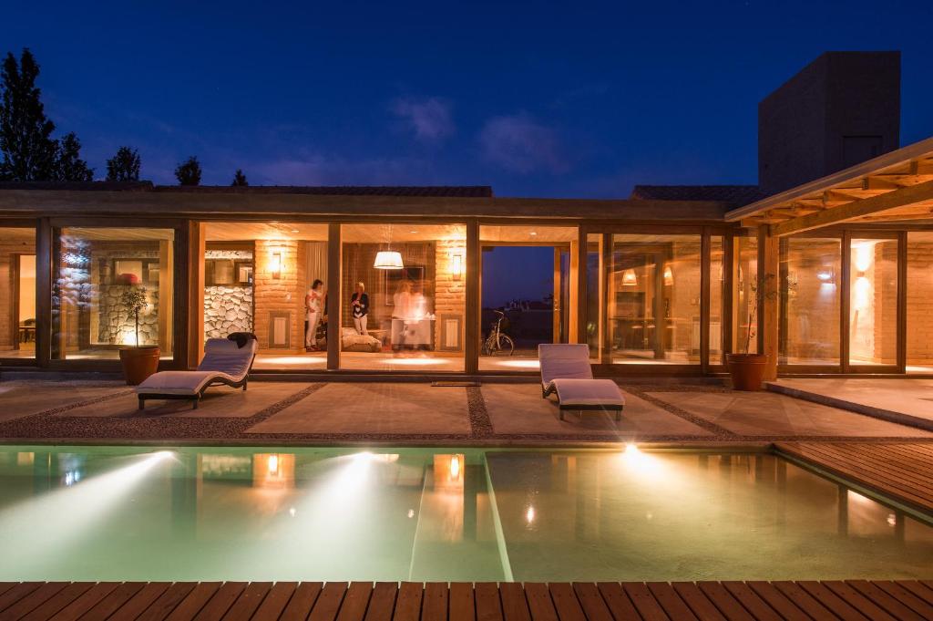 a house with a swimming pool at night at Adobe Charm in Cafayate