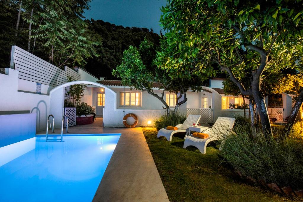 a swimming pool in the yard of a house at night at Amelie Villa in Ixia