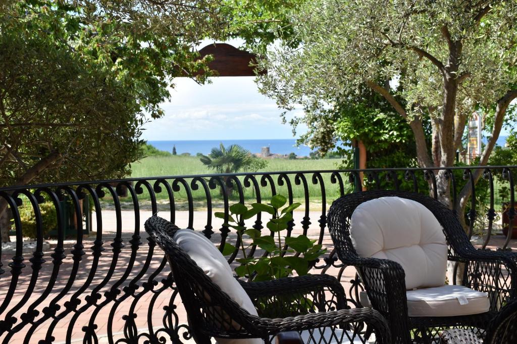 two chairs sitting on a wrought iron fence at Guest House Fortuna in Novigrad Istria