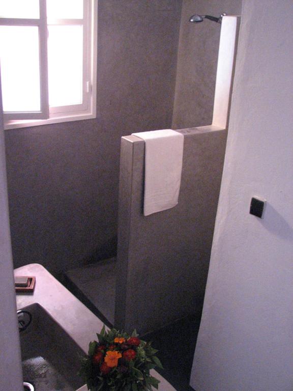 a bathroom with a toilet and a sink and a mirror at Maison Xanadu in Sidi Ifni