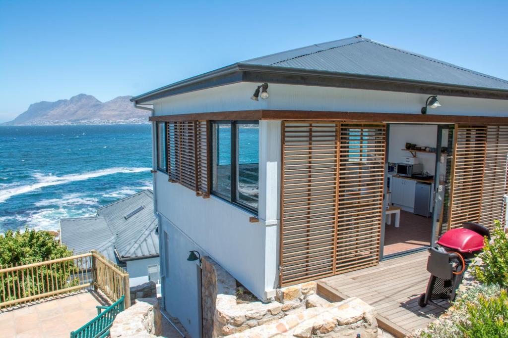 een huis met uitzicht op de oceaan bij Modern Beach Apartment in Kalk Bay