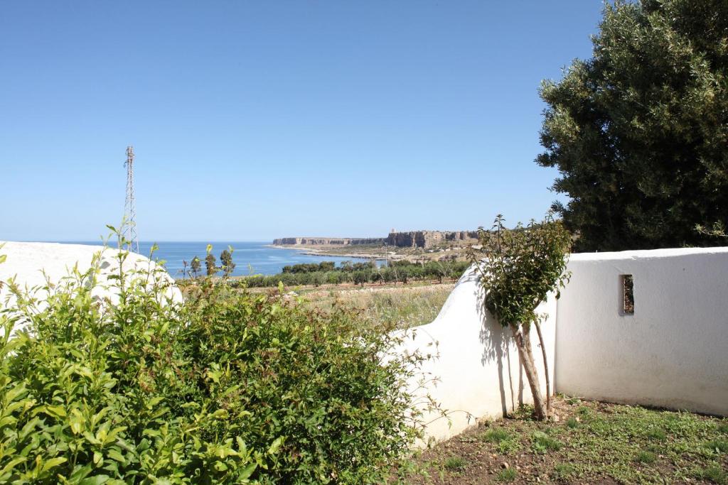 a white wall with a view of the ocean at Country Villa San Vito Bay in San Vito lo Capo