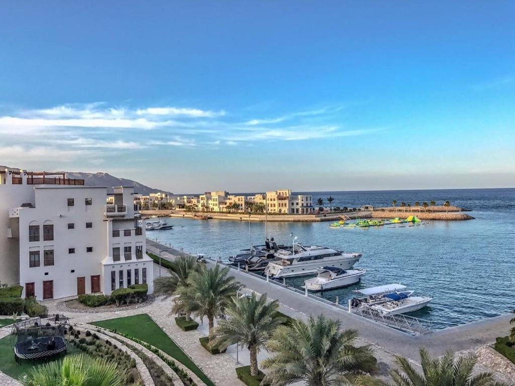 a view of a harbor with boats in the water at Apartment in Jebel Sifah in As Sīfah