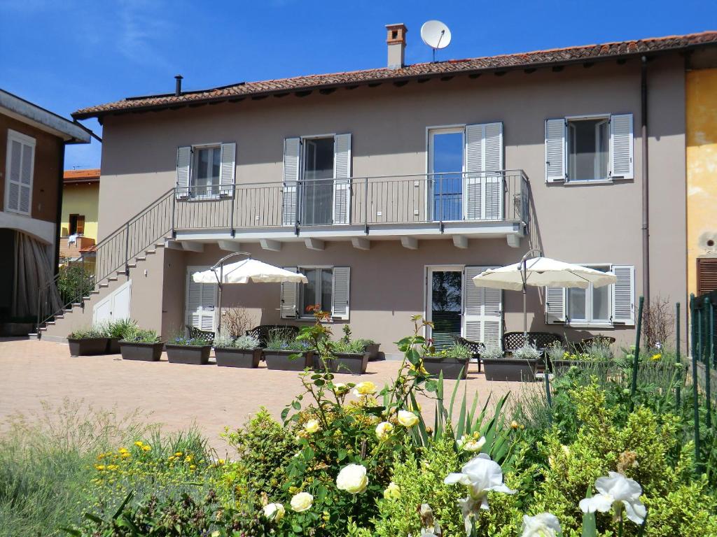 a large building with umbrellas in front of it at Marco Green House in Bellinzago Lombardo